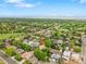 Overhead shot showing the property nestled in a green neighborhood with mountain views in the background at 3444 S Bellaire St, Denver, CO 80222