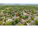 An aerial view of the property showcases its location in a lush, green neighborhood with surrounding trees at 3444 S Bellaire St, Denver, CO 80222