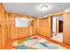 Cozy basement featuring paneled walls, storage cabinets, a mirror and colorful carpet at 3444 S Bellaire St, Denver, CO 80222