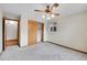 Bedroom featuring a ceiling fan, plush carpet, closet with light and a window offering natural light at 3444 S Bellaire St, Denver, CO 80222