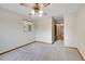 Bedroom showing carpet, ceiling fan, and window with brick view at 3444 S Bellaire St, Denver, CO 80222