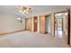 Large bedroom featuring carpet, ceiling fan, and multiple closets at 3444 S Bellaire St, Denver, CO 80222