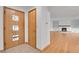 Inviting entryway with coat closet, leading to living room with decorative fireplace and built-ins at 3444 S Bellaire St, Denver, CO 80222