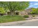 Charming brick home features a landscaped front yard with mature trees, a walkway, and an attached garage at 3444 S Bellaire St, Denver, CO 80222