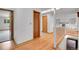 Bright hallway featuring hardwood floors, with views to the living room and stairs at 3444 S Bellaire St, Denver, CO 80222