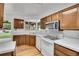 Bright kitchen with wood cabinets and white appliances at 3444 S Bellaire St, Denver, CO 80222