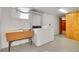 Functional laundry area featuring a utility sink, washer, dryer, and access door at 3444 S Bellaire St, Denver, CO 80222