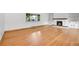 Bright living room showcases hardwood floors, a white stone fireplace, and a large picture window at 3444 S Bellaire St, Denver, CO 80222