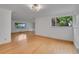 Bright living room features gleaming hardwood floors and large windows overlooking the landscaped yard at 3444 S Bellaire St, Denver, CO 80222