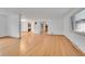 Open concept living room featuring hardwood floors, with access to other rooms in the home at 3444 S Bellaire St, Denver, CO 80222