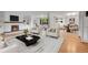 Bright living room showcases hardwood floors, a white stone fireplace, large picture window, and comfortable seating at 3444 S Bellaire St, Denver, CO 80222