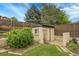 Small backyard shed, offering a practical storage solution in a landscaped setting at 3444 S Bellaire St, Denver, CO 80222