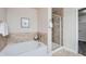 Modern bathroom featuring a separate tub and shower, plus tiled accents at 3611 S Perth Cir # 103, Aurora, CO 80013