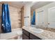 Well-lit bathroom featuring a tub with tile surround and granite countertops on the vanity at 3611 S Perth Cir # 103, Aurora, CO 80013