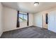 Well-lit bedroom showcasing neutral walls, large window with pleasant natural light, and plush carpeting at 3611 S Perth Cir # 103, Aurora, CO 80013