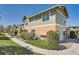 Townhouse complex featuring well-maintained lawns, landscaping, and an inviting exterior with a sidewalk at 3611 S Perth Cir # 103, Aurora, CO 80013
