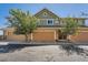 Townhome featuring well-manicured landscaping, a private garage, and a welcoming front entrance at 3611 S Perth Cir # 103, Aurora, CO 80013