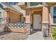 Charming home entrance with stone accents, a porch with a grill, and a welcoming front door at 3611 S Perth Cir # 103, Aurora, CO 80013