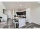 Open kitchen featuring a center island with bar stools, modern appliances, and sleek cabinetry at 3611 S Perth Cir # 103, Aurora, CO 80013