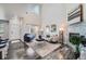 Bright living room featuring a high ceiling, modern fireplace, and stylish furnishings at 3611 S Perth Cir # 103, Aurora, CO 80013