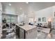 Bright living space featuring a modern kitchen island, dining area, and stylishly decorated living room with neutral tones at 3611 S Perth Cir # 103, Aurora, CO 80013