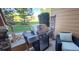 Outdoor grill on a porch overlooking a lawn and trees with a chair at 3611 S Perth Cir # 103, Aurora, CO 80013