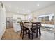 Modern kitchen with white cabinets, stainless steel appliances, and island at 46545 Orchard Dr, Bennett, CO 80102