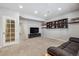 Finished basement with a door leading to stairs, a sofa and a large TV at 25843 E Archer Dr, Aurora, CO 80018