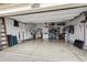 Organized two-car garage with storage racks and a clean, epoxy-coated floor at 25843 E Archer Dr, Aurora, CO 80018