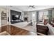 Spacious living room featuring a fireplace, plush carpet, and natural light at 25843 E Archer Dr, Aurora, CO 80018