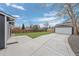 Spacious backyard with well manicured lawn, detached garage, concrete pad, and privacy fence at 18866 W 59Th Pl, Golden, CO 80403