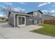 View of home's backyard with fenced in area, sliding glass doors, well manicured lawn, and mature trees at 18866 W 59Th Pl, Golden, CO 80403