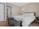Comfortable bedroom with a neutral color palette and access to an adjacent room at 18866 W 59Th Pl, Golden, CO 80403