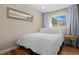 Serene bedroom with neutral walls, wood floors, a comfortable bed, and a window with natural light at 18866 W 59Th Pl, Golden, CO 80403