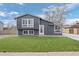 Charming two-story home with a well-manicured lawn, gray siding and white trim at 18866 W 59Th Pl, Golden, CO 80403