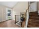 Inviting foyer with wood floors, staircase with brass railings and view into living room at 18866 W 59Th Pl, Golden, CO 80403