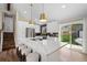 Bright, remodeled kitchen with island seating, stainless appliances, and sliding door access to backyard at 18866 W 59Th Pl, Golden, CO 80403
