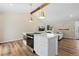 Kitchen island featuring built-in stainless steel oven and additional counter space, open to living area at 18866 W 59Th Pl, Golden, CO 80403