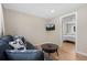 This cozy living room features a plush couch, wood-look floors, and a wall-mounted TV for relaxation and entertainment at 18866 W 59Th Pl, Golden, CO 80403