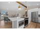 Modern kitchen island, open to the living room, featuring stainless appliances and natural light at 18866 W 59Th Pl, Golden, CO 80403