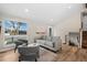 Cozy living room features stylish furniture, vaulted ceilings, and natural light from a large window at 18866 W 59Th Pl, Golden, CO 80403