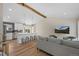 Spacious open-concept living and dining area, seamlessly connecting to a stylish modern kitchen at 18866 W 59Th Pl, Golden, CO 80403