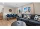 Spacious living area featuring a comfortable couch, wood floors, and windows allowing natural light to fill the room at 18866 W 59Th Pl, Golden, CO 80403
