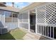 Cozy covered back porch with lattice details, and a small grassy yard at 2608 E Fremont Pl, Centennial, CO 80122