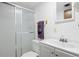 Bathroom featuring shower with clear door, toilet and vanity with ample counter space at 2608 E Fremont Pl, Centennial, CO 80122