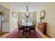 Warm dining room featuring a classic chandelier and hardwood floors at 2608 E Fremont Pl, Centennial, CO 80122