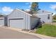 Exterior view of the home with a two-car garage and well-maintained landscaping at 2608 E Fremont Pl, Centennial, CO 80122