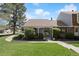 Charming home with a well-manicured lawn, mature trees, and a welcoming front porch at 2608 E Fremont Pl, Centennial, CO 80122