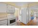 Kitchen featuring white appliances and light wood floors at 2608 E Fremont Pl, Centennial, CO 80122