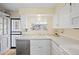 Bright kitchen featuring white cabinets and stainless steel dishwasher at 2608 E Fremont Pl, Centennial, CO 80122